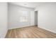 Bright bedroom featuring light-colored walls, wood floors and a window with blinds, and walk-in closet at 113 Alcester Rd, Goose Creek, SC 29445