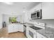 Bright kitchen featuring white cabinets, stainless steel appliances, granite countertops, and an eating area at 113 Alcester Rd, Goose Creek, SC 29445