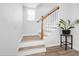Stylish staircase with wood railing, wood-capped treads, white risers, and natural light from the window at 113 Alcester Rd, Goose Creek, SC 29445