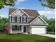 Charming two-story home featuring a covered porch, attached two-car garage, and beautifully landscaped front yard at 114 Shingle Oak Dr, Moncks Corner, SC 29461