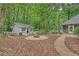 Spacious backyard with mature trees, featuring a charming outbuilding and a brick-paved patio at 1148 Black Rush Cir, Mount Pleasant, SC 29466