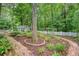 Beautiful landscaped backyard featuring a brick walkway and a charming shed at 1148 Black Rush Cir, Mount Pleasant, SC 29466