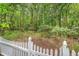 An uncultivated and untouched backyard featuring a white picket fence at 1148 Black Rush Cir, Mount Pleasant, SC 29466