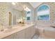 Bathroom with double vanity, wallpaper, and soaking tub at 1148 Black Rush Cir, Mount Pleasant, SC 29466