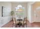 Elegant dining room with wainscotting, a stylish chandelier, and abundant natural light at 1148 Black Rush Cir, Mount Pleasant, SC 29466