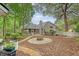 Inviting exterior showcasing a fire pit and a well-maintained lawn surrounded by mature trees at 1148 Black Rush Cir, Mount Pleasant, SC 29466