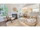 Open-concept living room flows seamlessly into the dining area, showcasing a modern fireplace and large windows at 1148 Black Rush Cir, Mount Pleasant, SC 29466
