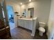 Bathroom with double sinks, a toilet, and stylish wood-look flooring, seamlessly blending convenience and design at 116 Gaura Ln, Summerville, SC 29483