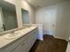 Bathroom featuring double sinks, a white vanity, and wood-look flooring, creating a clean and functional space at 116 Gaura Ln, Summerville, SC 29483