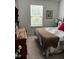 Bright bedroom featuring a window, dresser, and bed with quilt and red pillow at 116 Gaura Ln, Summerville, SC 29483