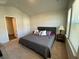 Bright bedroom offers neutral decor, plush carpeting, and a large window, creating a comfortable and inviting atmosphere at 116 Gaura Ln, Summerville, SC 29483
