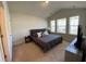 This primary bedroom boasts a large bed, natural light, and neutral decor, creating a serene and inviting space at 116 Gaura Ln, Summerville, SC 29483