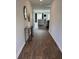 Elegant entryway featuring wood floors, a decorative mirror, and a glimpse into the open-concept living area at 116 Gaura Ln, Summerville, SC 29483