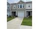 Charming two-story townhouse with a one car garage, well-maintained lawn, and neutral-toned exterior at 116 Gaura Ln, Summerville, SC 29483