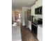 Modern kitchen with white cabinets, stainless appliances, and an open view to the entryway at 116 Gaura Ln, Summerville, SC 29483