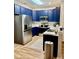 Modern kitchen with stainless steel appliances, blue cabinets, and sleek countertops at 123 Lynches River Dr, Summerville, SC 29485