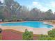 Large community pool with perimeter fence, landscaping, and blue sky above at 123 Lynches River Dr, Summerville, SC 29485