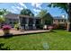 Spacious backyard featuring a brick patio, screened-in porch, and lush artificial grass at 1231 Wild Olive Dr, Mount Pleasant, SC 29464