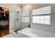 Bright bathroom with walk in glass shower, separate tub and closet at 1231 Wild Olive Dr, Mount Pleasant, SC 29464