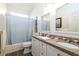 Bathroom with double mirrors, vanity, toilet, tub, and shower with blue curtain at 1231 Wild Olive Dr, Mount Pleasant, SC 29464