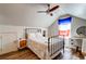 Bedroom features wood floors, a ceiling fan, a black bed frame, and a modern nightstand at 1231 Wild Olive Dr, Mount Pleasant, SC 29464