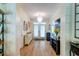 Bright foyer with hardwood floors, chandelier, and view of the double-door front entrance at 1231 Wild Olive Dr, Mount Pleasant, SC 29464