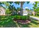 Charming single-story home with a well-manicured lawn, palm trees, and an attached two-car garage at 1231 Wild Olive Dr, Mount Pleasant, SC 29464