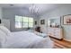 Bright main bedroom features a high ceiling, modern light fixture, and large window at 1231 Wild Olive Dr, Mount Pleasant, SC 29464