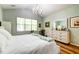 Bright main bedroom features a high ceiling, modern light fixture, and large window at 1231 Wild Olive Dr, Mount Pleasant, SC 29464