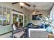Covered patio with comfortable seating, a ceiling fan, outdoor TV, and nice flowers at 1231 Wild Olive Dr, Mount Pleasant, SC 29464