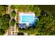 Community pool with ample lounge chairs, surrounded by mature trees and a nearby lake at 1231 Wild Olive Dr, Mount Pleasant, SC 29464