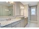 Beautiful bathroom featuring double vanities, stone countertops, and a glass-enclosed shower at 1363 Rivella Dr, Mount Pleasant, SC 29464