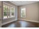 Serene bedroom featuring dark hardwood floors and natural light streaming through large windows at 1363 Rivella Dr, Mount Pleasant, SC 29464