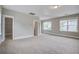 Bright, open bedroom with three windows, a walk-in closet and neutral carpeting at 1363 Rivella Dr, Mount Pleasant, SC 29464