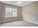 Inviting bedroom with large window, a ceiling fan, and plush carpet flooring at 1363 Rivella Dr, Mount Pleasant, SC 29464