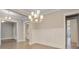 Elegant dining area showcasing modern wainscoting and a contemporary chandelier enhancing the bright, open space at 1363 Rivella Dr, Mount Pleasant, SC 29464