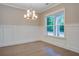 Bright dining room featuring chair rail molding, hardwood floors, and a modern chandelier fixture at 1363 Rivella Dr, Mount Pleasant, SC 29464