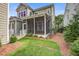 Exterior view of home with a screened in porch, lush lawn, and manicured landscaping at 1363 Rivella Dr, Mount Pleasant, SC 29464