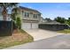 Two-story home featuring a two-car garage, concrete driveway and dark wood fence at 1363 Rivella Dr, Mount Pleasant, SC 29464