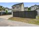 Charming two-story home featuring a two car garage, concrete driveway and dark wood fence at 1363 Rivella Dr, Mount Pleasant, SC 29464