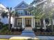 Charming two-story home with gray siding, white columns, front porch, landscaped yard, and mature palm trees at 1363 Rivella Dr, Mount Pleasant, SC 29464