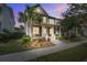 Charming two-story home featuring a welcoming front porch, manicured landscaping, and a beautiful palm tree at 1363 Rivella Dr, Mount Pleasant, SC 29464