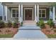 Inviting front porch with classic columns, a double door entry, and professionally landscaped surroundings at 1363 Rivella Dr, Mount Pleasant, SC 29464