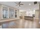 Bright open living space with hardwood floors, view of the kitchen, and large windows at 1363 Rivella Dr, Mount Pleasant, SC 29464