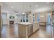 Spacious living area featuring a fireplace, built-ins, hardwood floors, and a large kitchen island with a sink at 1363 Rivella Dr, Mount Pleasant, SC 29464