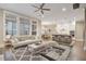 Open-concept living room with view of kitchen, lots of natural light, and hardwood floors at 1363 Rivella Dr, Mount Pleasant, SC 29464