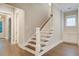 Bright staircase features dark hardwood steps, white risers and trim, and a natural wood handrail at 1363 Rivella Dr, Mount Pleasant, SC 29464