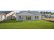 Expansive backyard with lush green lawn, a covered porch, and sliding glass doors at 137 Summerwind Dr, Summerville, SC 29486