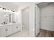 Bright bathroom featuring double vanity with sleek black fixtures and an adjacent walk-in closet at 137 Summerwind Dr, Summerville, SC 29486