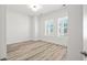 Bright, empty bedroom with two windows and light LVP flooring at 137 Summerwind Dr, Summerville, SC 29486